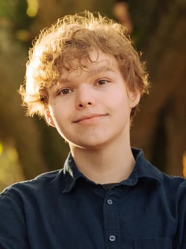 Nick Oates standing in front of of a tree